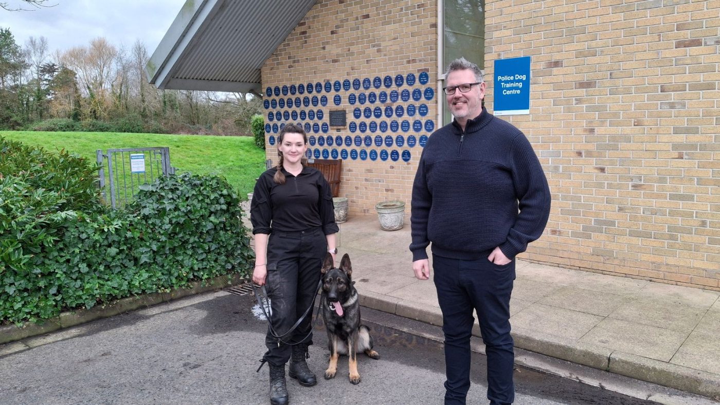 Sgt Vicki Hallett with police dog in training PD Solo and PCC John Campion outside the Police Dog Training Centre