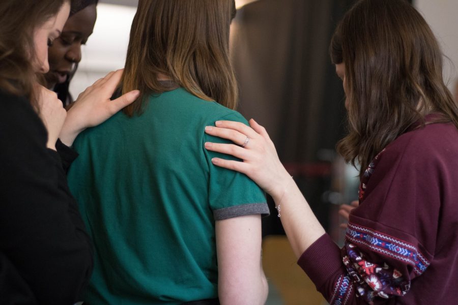 Stock image of a women putting her hand on someone's shoulder