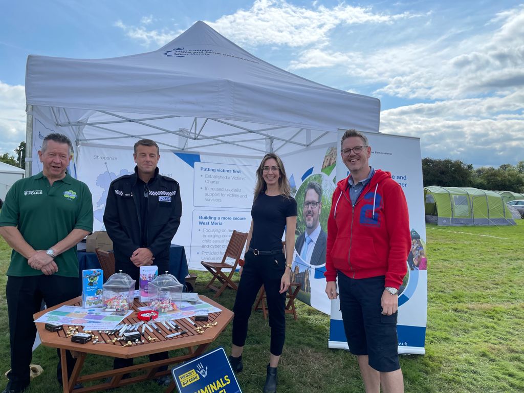 PCC John Campion joined by 3 people, stood outside a gazebo at a summer event
