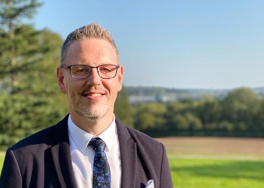 PCC John Campion smiling in a green field